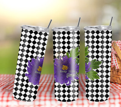 Three tumblers with black and white checkered pattern and purple floral design on a blurred outdoor background.