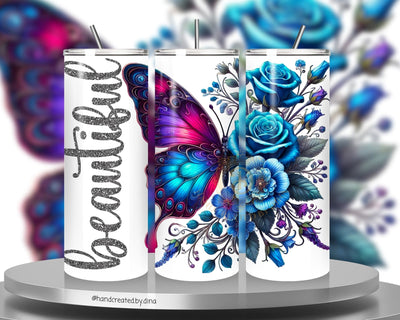 Three white tumblers with colourful butterfly and floral designs on a stand.