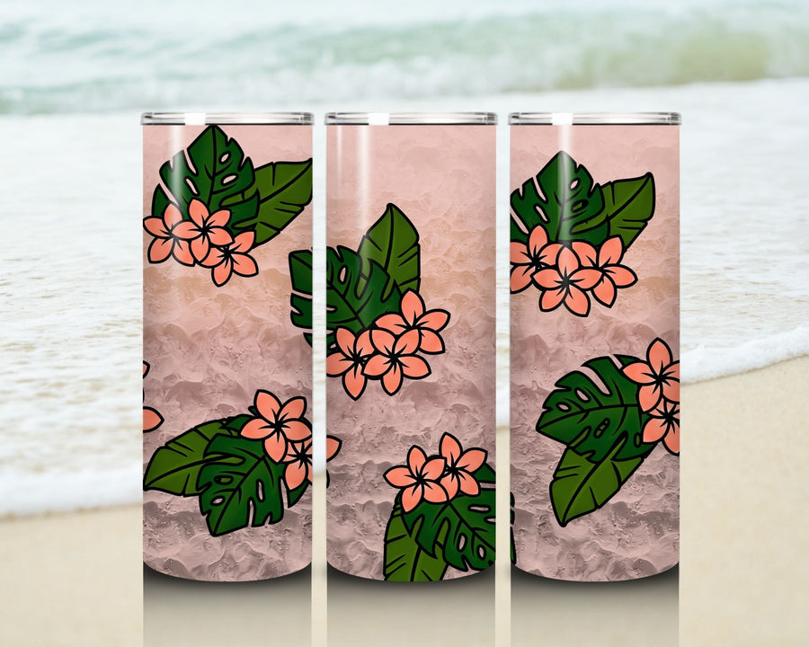 Three stainless steel tumblers with floral and leaf design on a beach background
