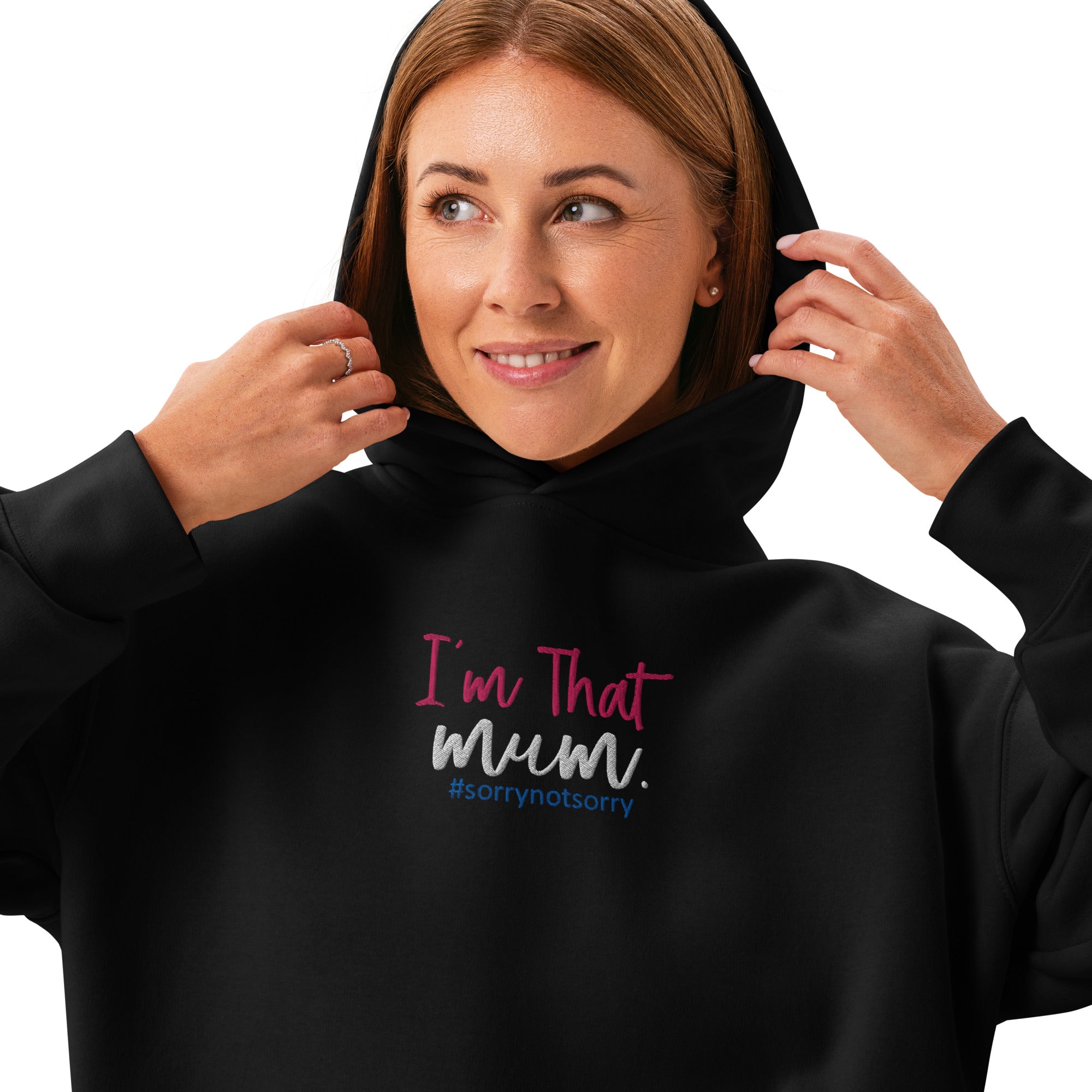 Woman wearing a black hoodie with text 'I'm That Mum. sorrynotsorry' on a white background