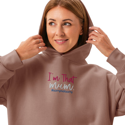 Woman wearing a brown hoodie with text 'I'm That Mum. #sorrynotsorry' on a white background