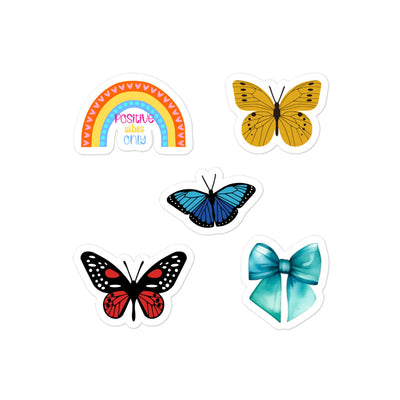 Colourful butterfly and rainbow stickers on a white background.