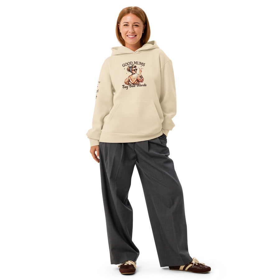 Person wearing a beige hoodie with graphic design and text, standing against a white background