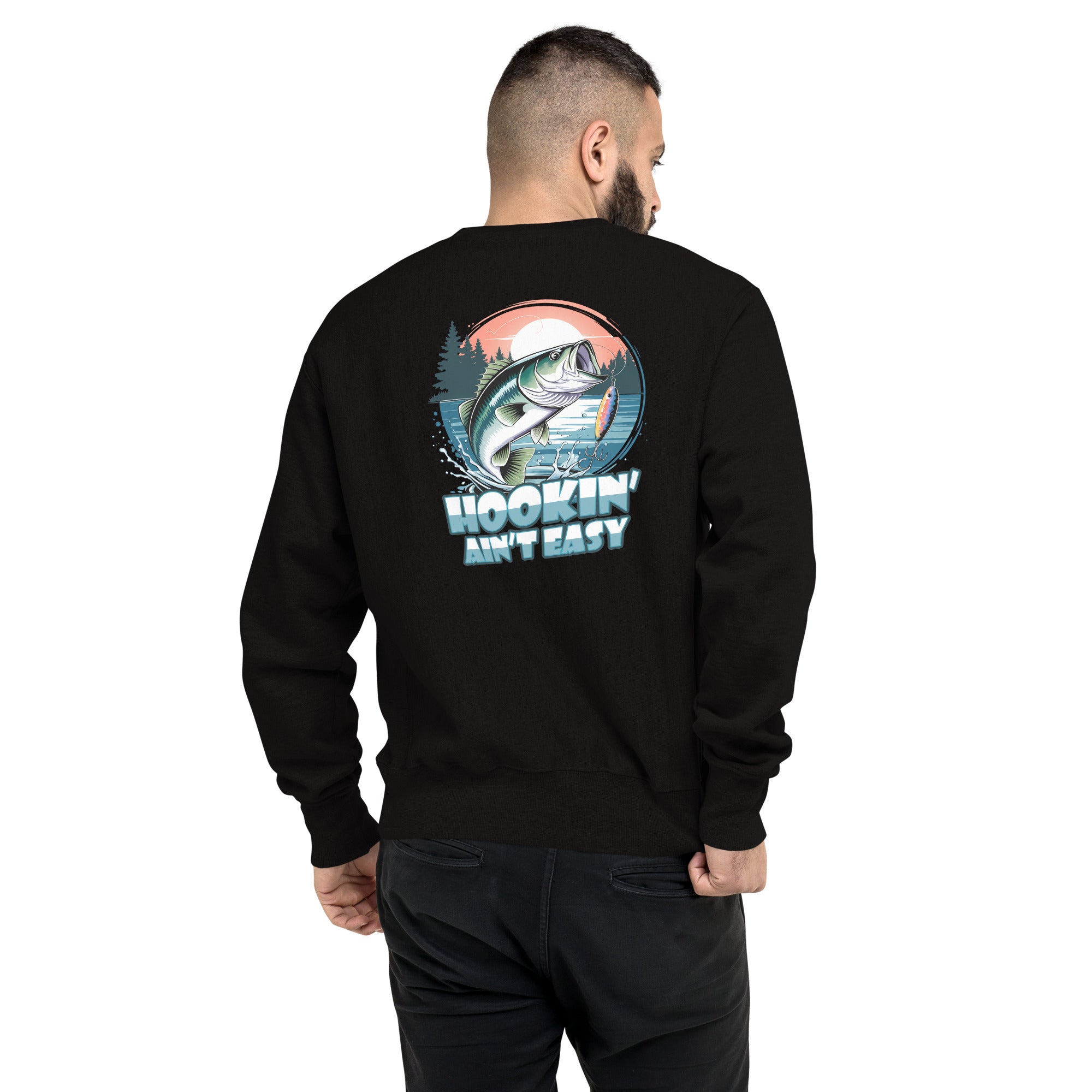 Man wearing a black sweatshirt with a fish graphic and text on the back, on a white background