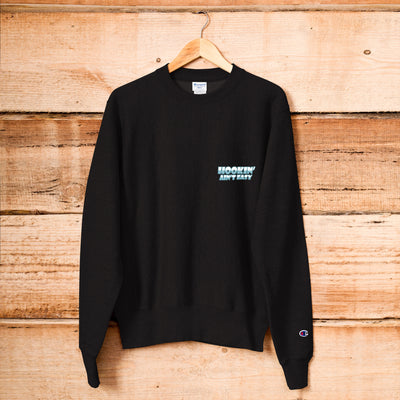 Black sweatshirt with text on a wooden background
