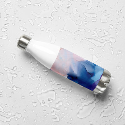 White water bottle with blue and pink marbled design on a wet surface