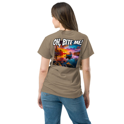 Woman wearing a brown t-shirt with a scenic design and 'OH, BITE ME!' text on the back.
