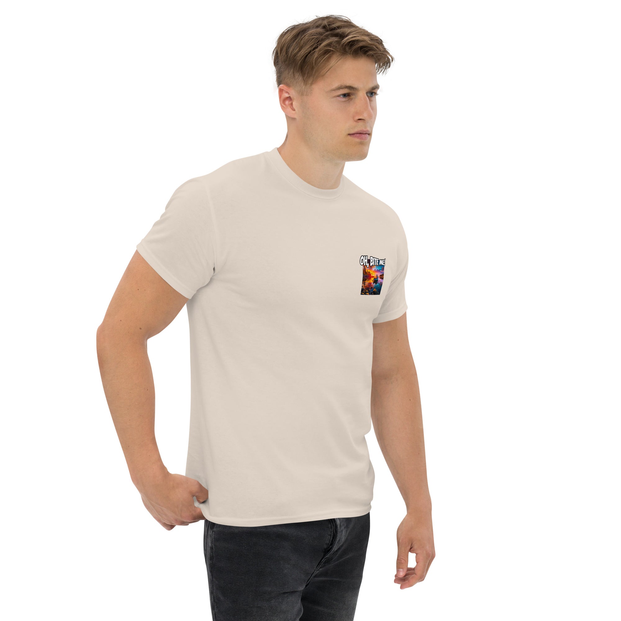 Man wearing a beige t-shirt with a small fish logo on a white background