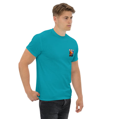 Man wearing a teal t-shirt with a small fish logo on a white background