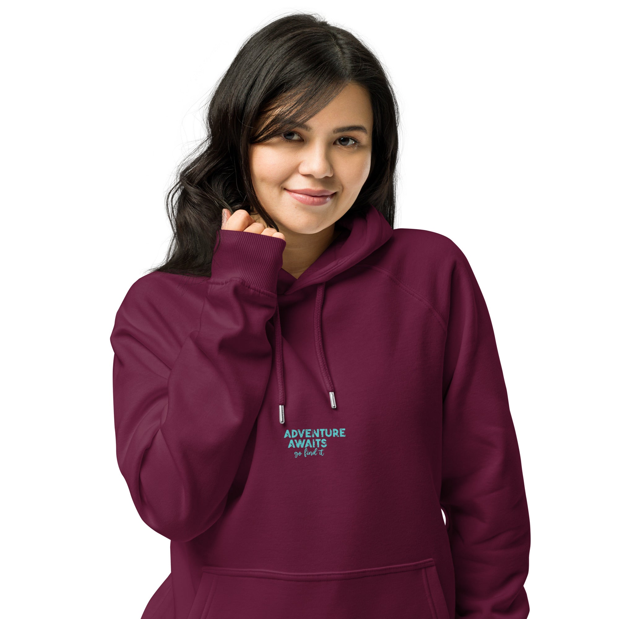 Woman wearing a maroon hoodie with 'Adventure Awaits' text on a white background