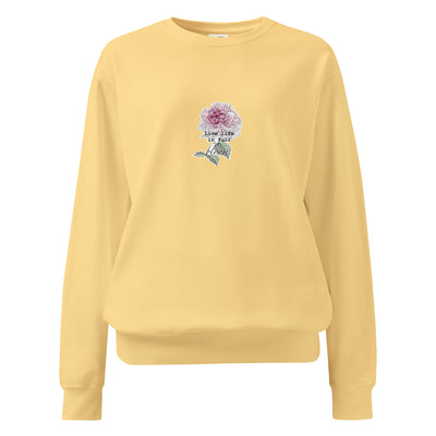 Yellow sweatshirt with a floral design and text on a white background