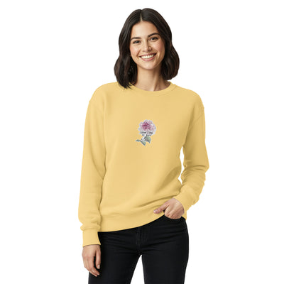 Woman wearing a yellow sweatshirt with a graphic design on a white background