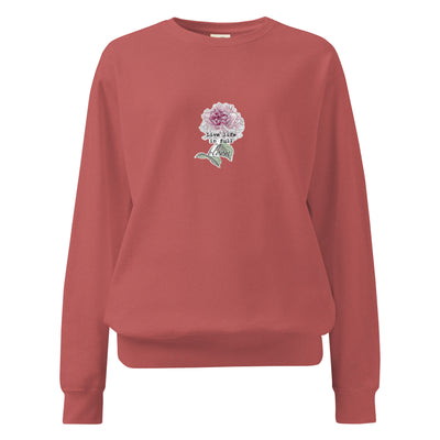Red sweatshirt with a floral design and text on a white background