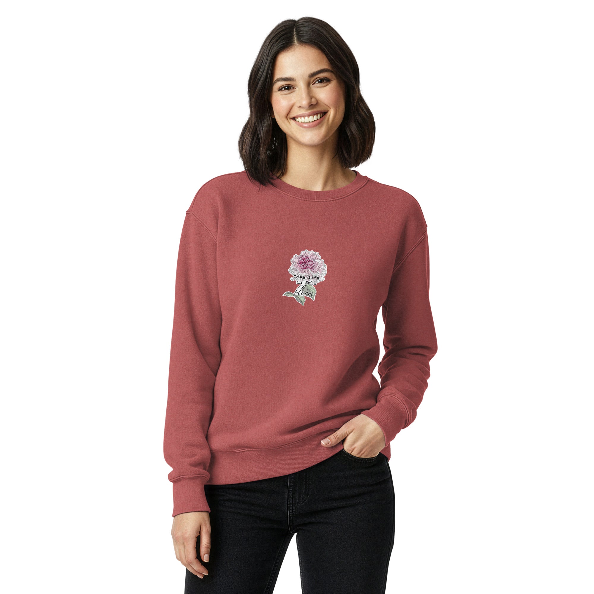 Woman wearing a maroon sweatshirt with a floral design on a white background