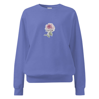 Blue sweatshirt with a floral design and text on a white background
