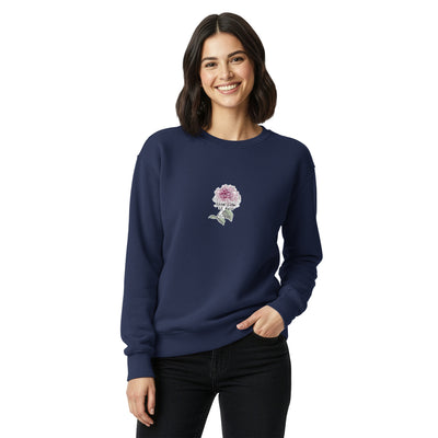 Woman wearing a navy blue sweatshirt with a floral design on a white background