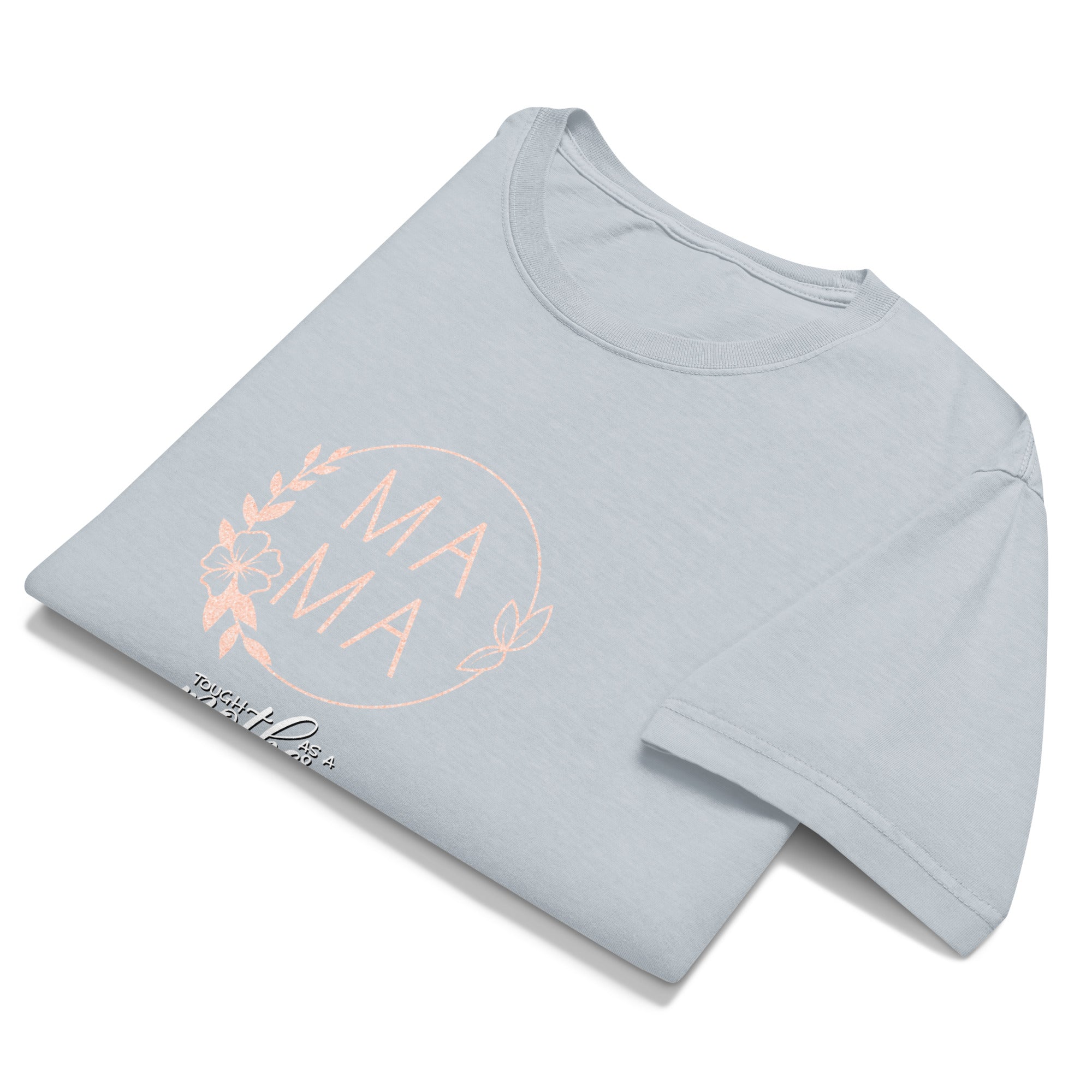 Folded light blue t-shirt with 'MAMA' print on a white background