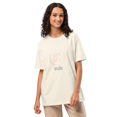 Woman wearing a vintage white t-shirt with 'MAMA' text on a plain background