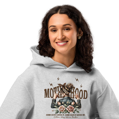 Person wearing a gray hoodie with a graphic design and text on a white background