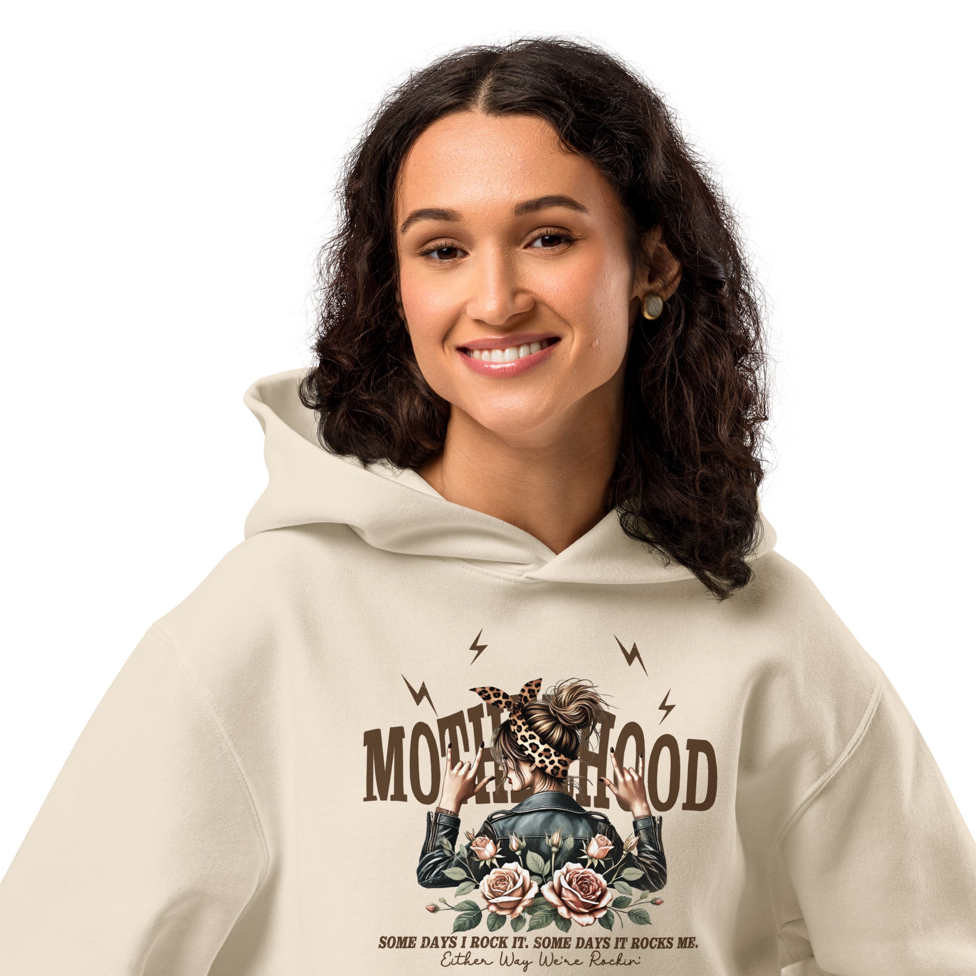 Woman wearing a beige hoodie with a graphic design and text on a white background