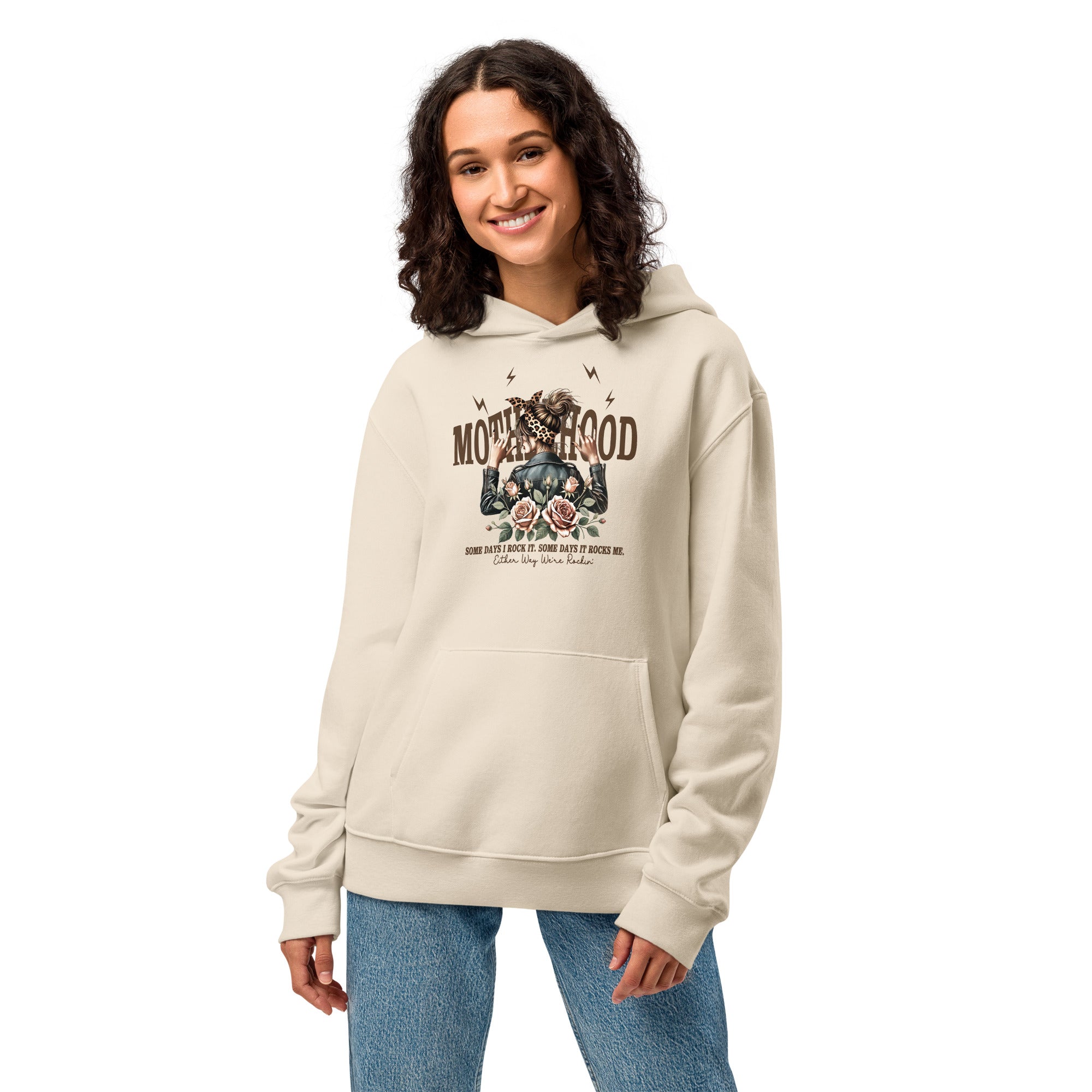 Woman wearing a beige hoodie with graphic design on a white background