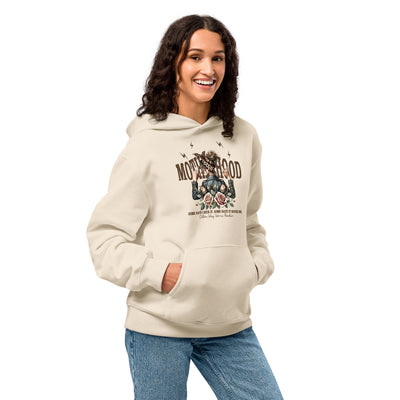 Woman wearing a beige hoodie with graphic design on a white background