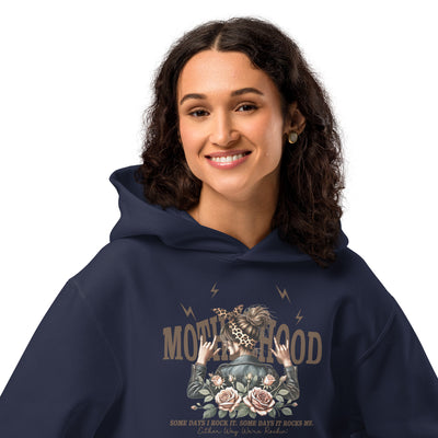 Person wearing a navy hoodie with a graphic design on a white background