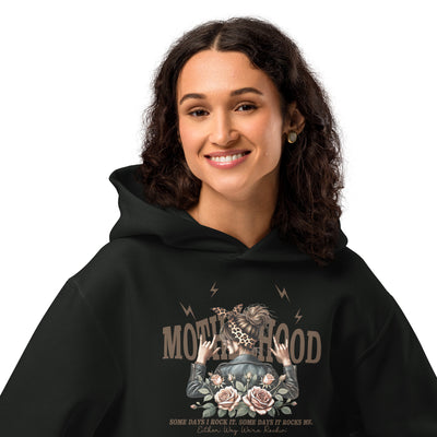 Person wearing a black hoodie with a graphic design on a white background