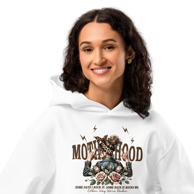 Woman wearing a white hoodie with a graphic design and text on a white background