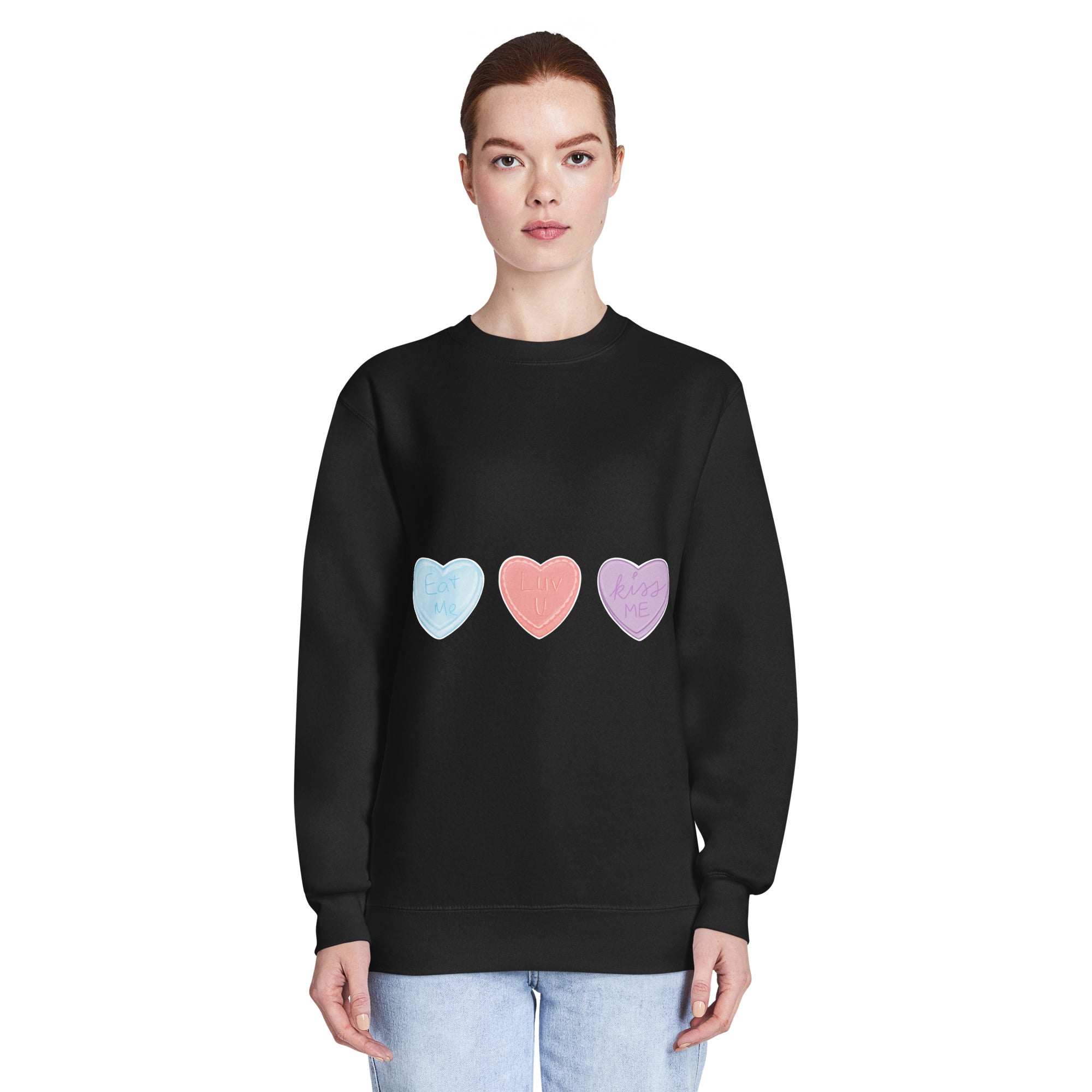 Person wearing a black sweatshirt with colourful heart designs on a white background