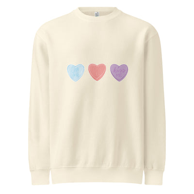 Beige sweatshirt with colourful heart designs on a white background