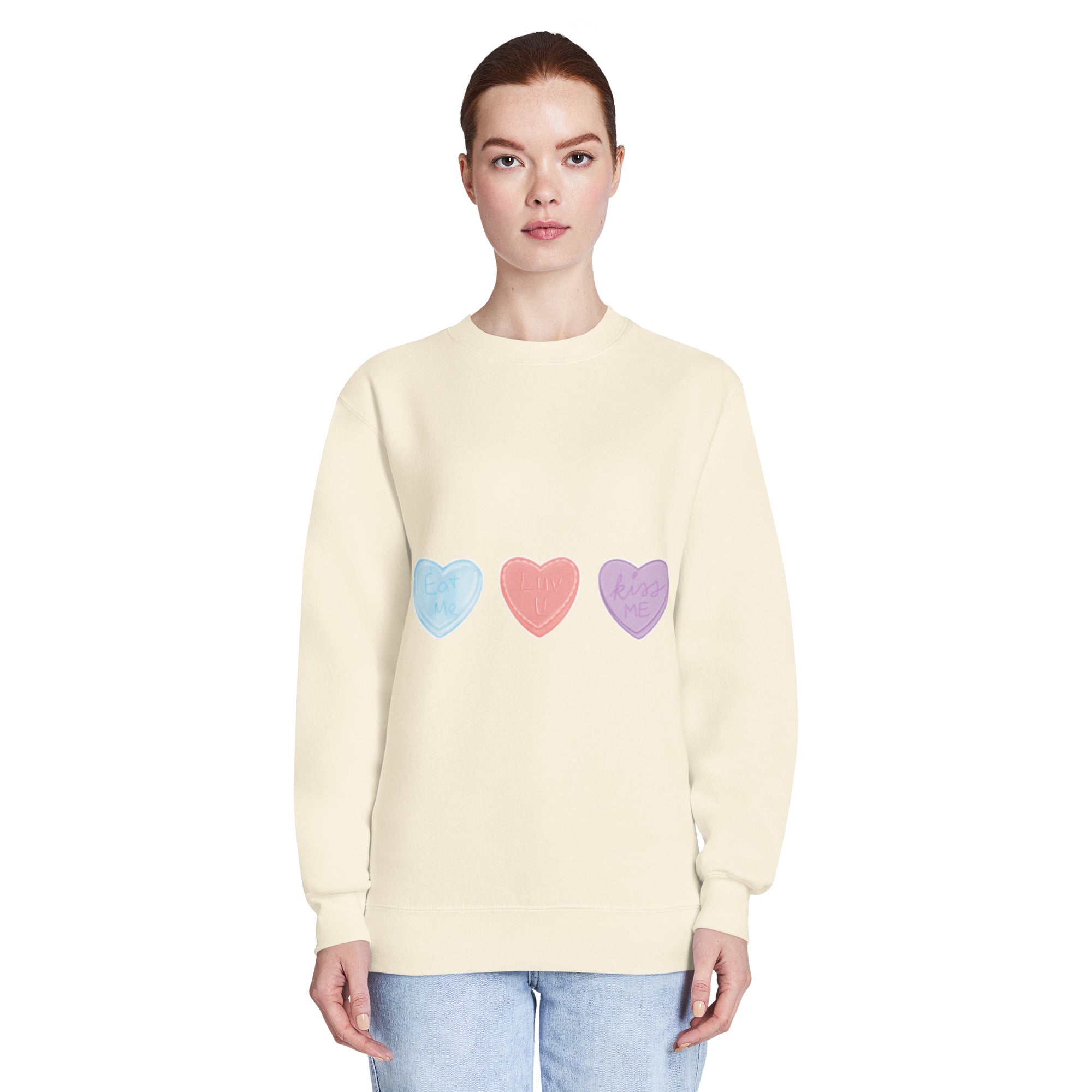 Woman wearing a light yellow sweater with colourful heart patterns on a white background