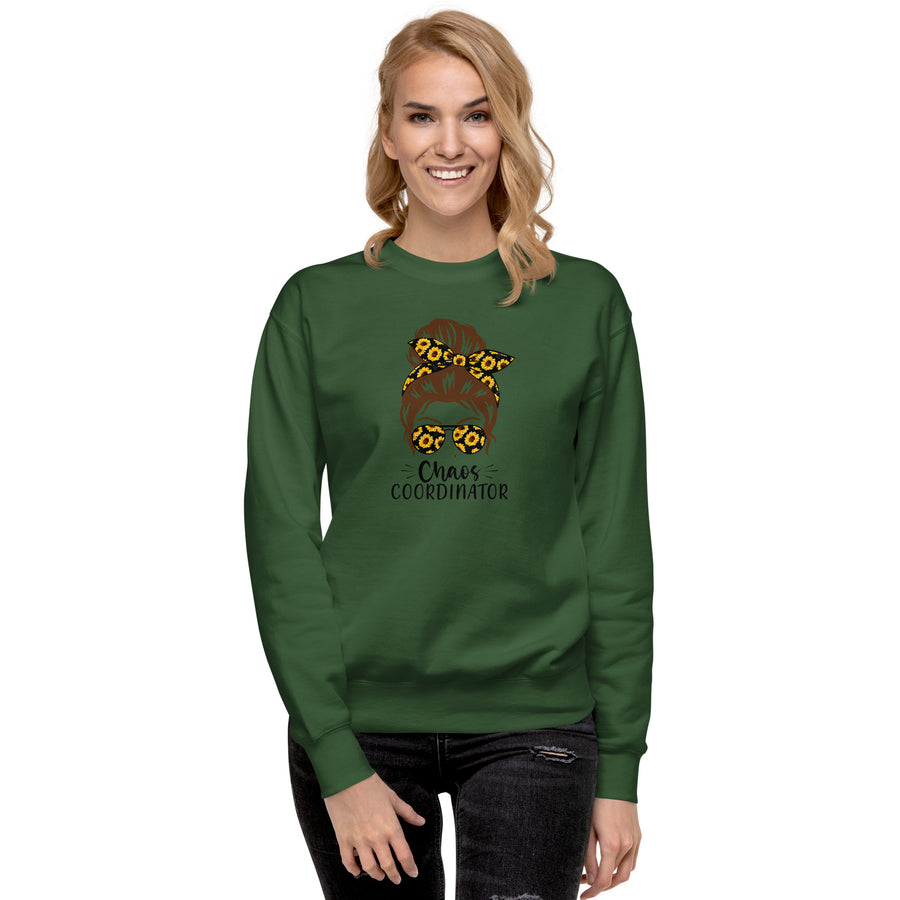 A woman smiling and wearing a green sweatshirt with a gold and brown girl print design
