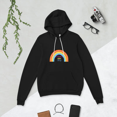 Black hoodie with a colourful rainbow design on a light gray background