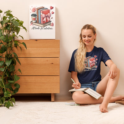 Woman sitting on the floor with a book, next to a wooden dresser with a decorative sign.