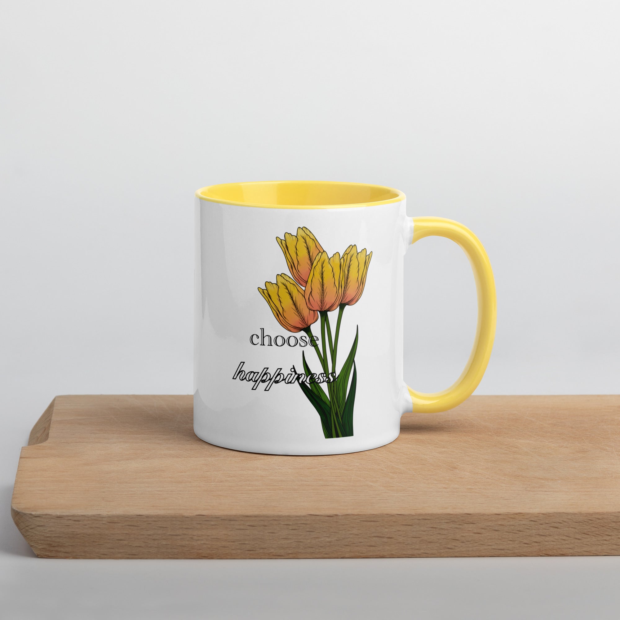 Mug with yellow tulips and 'choose happiness' text on a wooden surface