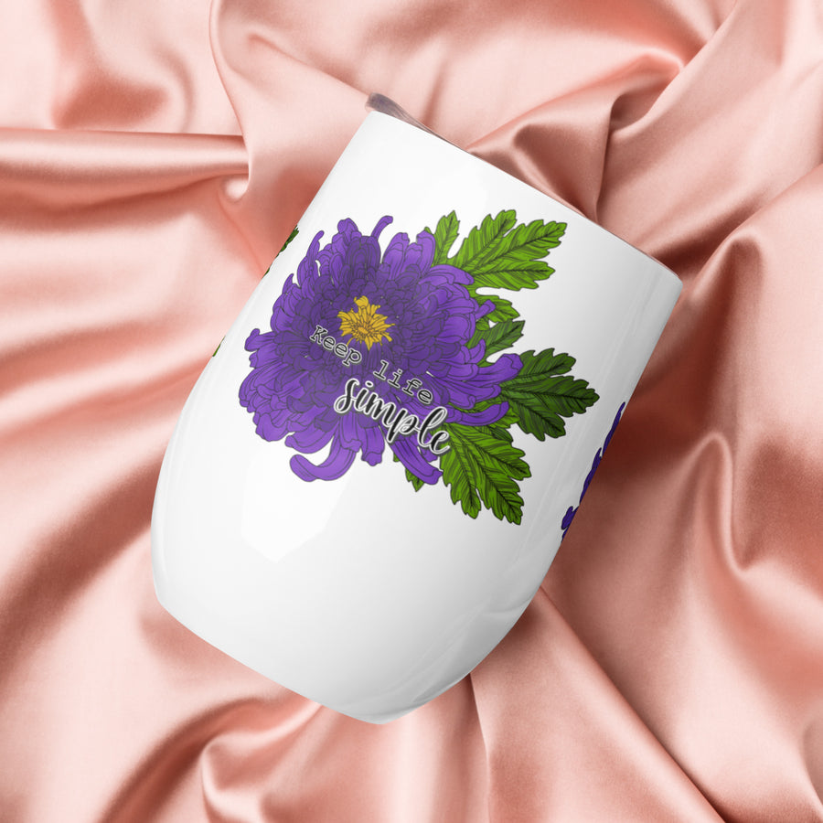 White mug with purple floral design and 'Keep Life Simple' text on pink satin fabric