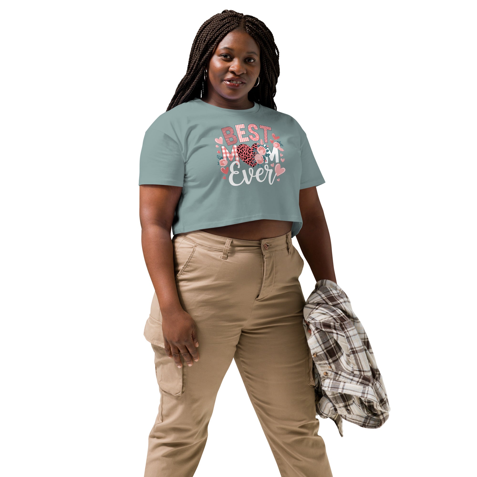 Woman wearing a green t-shirt with 'Best Mum Ever' text and beige pants on a white background