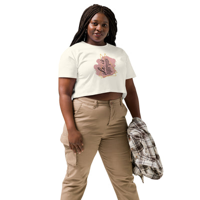 Woman wearing a natural crop with a motivational text quote design and beige pants on a white background