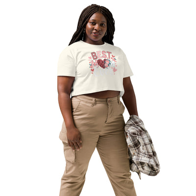 Woman wearing a white t-shirt with a graphic design and beige pants on a white background