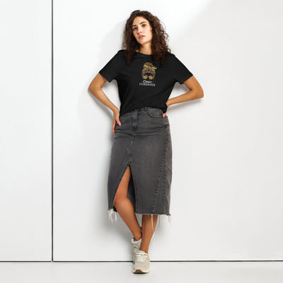 Woman wearing a black t-shirt with a girl logo and 'Chaos Co-ordinator' text, and a black denim skirt on a white background