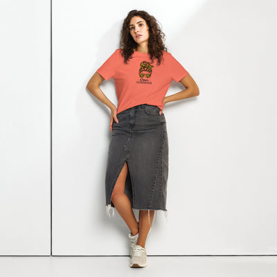 Woman wearing a coral t-shirt with a graphic girl design and 'Chaos Co-ordinator' text, a black denim skirt on a white background