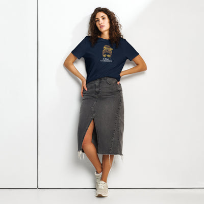 Woman wearing a navy t-shirt with a girl logo and a black denim skirt on a white background