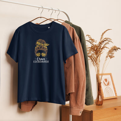 Navy blue t-shirt with graphic girl design and 'Chaos Co-ordinator' text on a hanger against a neutral background.
