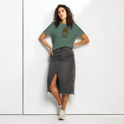Woman wearing a green t-shirt with a graphic design and 'Chaos Co-ordinator' text and a black denim skirt on a white background