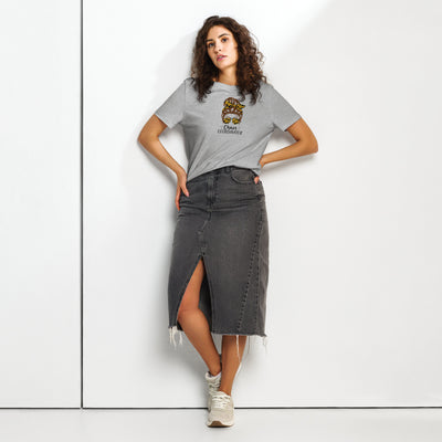 Woman wearing a grey t-shirt with a girl logo and a denim skirt on a white background