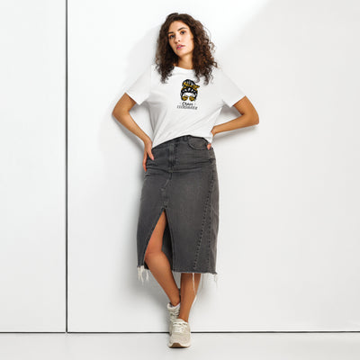 Woman wearing a white t-shirt with a graphic girl design and a black denim skirt on a white background